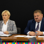 Stanisław Derehajło, Wicemarszałek Województwa Podlaskiego i Agnieszka Aleksiejczku,Dyrektor Departamentu Społeczeństwa Informacyjnego UMWP siedzący przy stole z dokumentami.