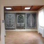 Tkanina dwuosnowową -dywany wyeksponowane na ścianie sali wystawowej 