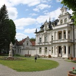 Pałac Buchholtzów w otoczeniu drzew.