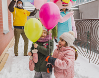 Dwie dziewczynki trzymają w rączkach balony.