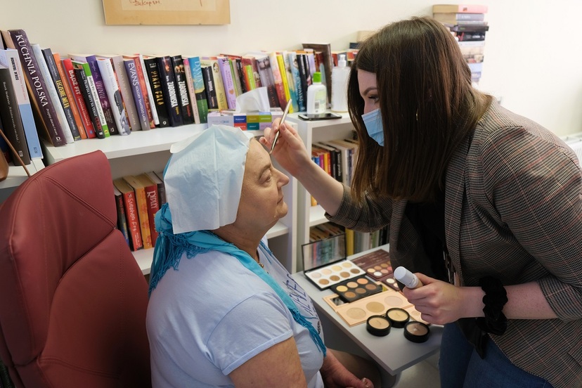 Wolontariuszka ze Stowarzyszenia Eurydyki wykonuje makijaż pacjentce Centrum Onkologii.