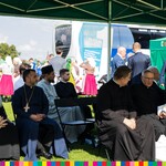 Osoby duchowne siedzą pod namiotem podczas Dożynek Wojewódzkich 2021
