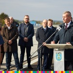 Burmistrz Łap, Krzysztof Gołaszewski mówi do mikrofonu. Za nim stoją inne osoby uczestniczące w wydarzeniu