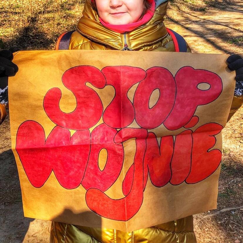 Kobieta trzymająca transparent: stop wojnie